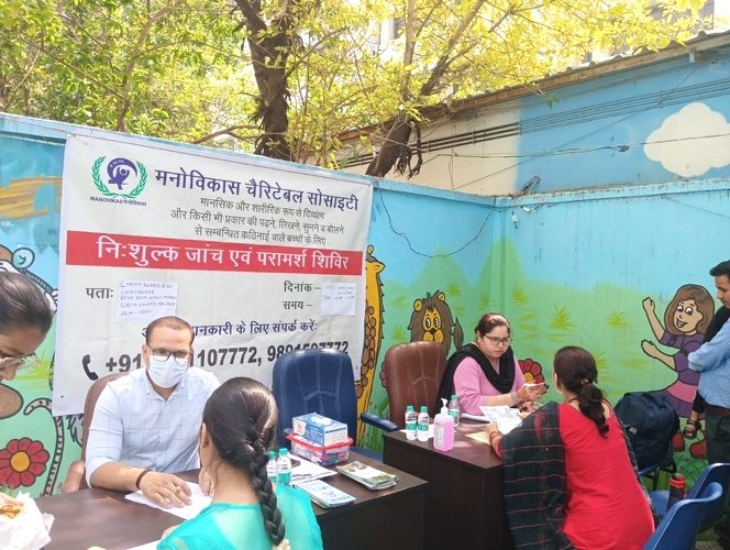 Families meeting specialists at a free Manovikas assessment and counselling camp