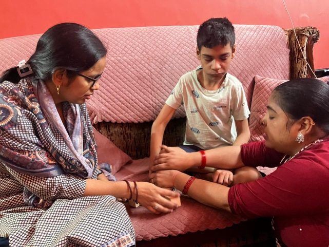 Educators coaching a parent during a home visit