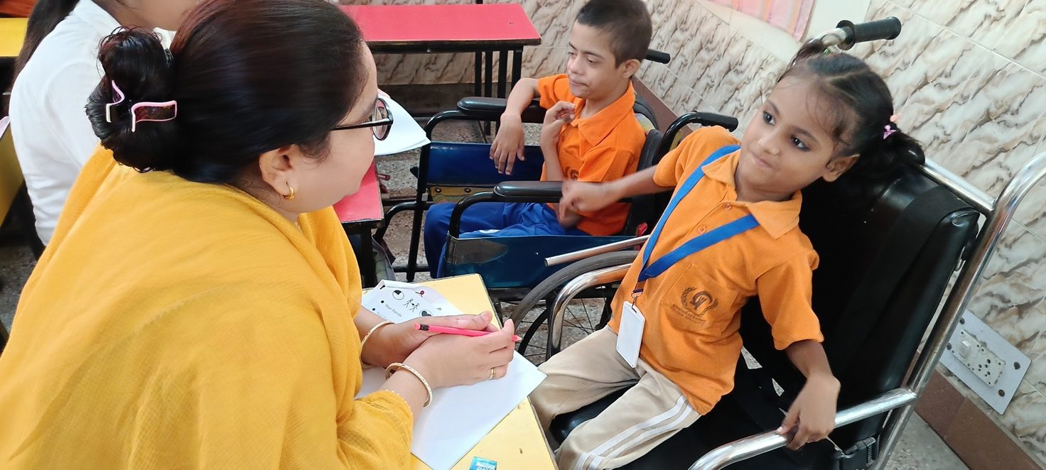 An educator giving one-to-one support to children in the classroom