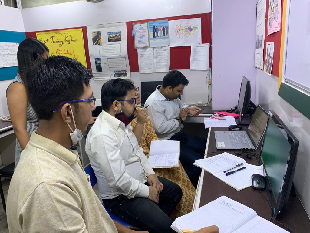 Trainers and staff working at the computers in the ACE Lab