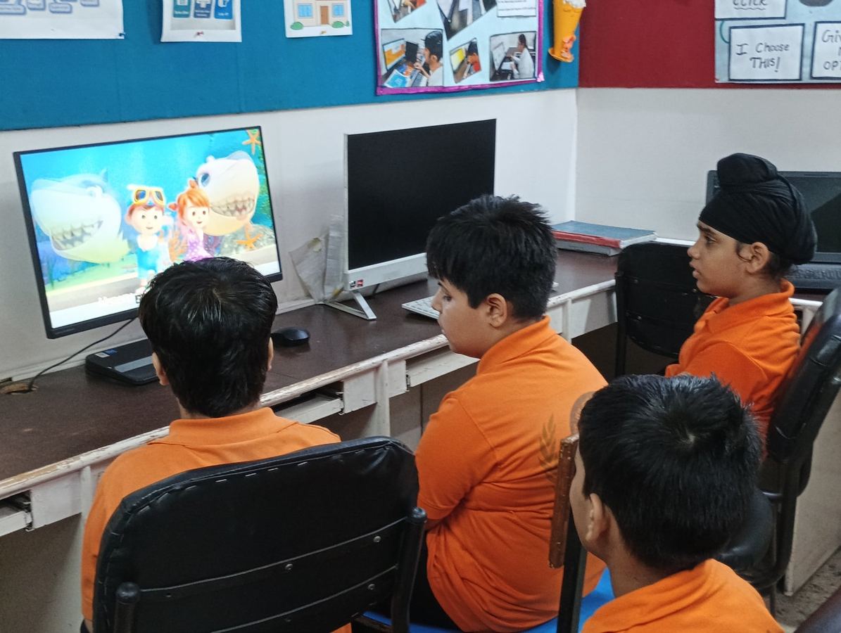 A group of learners at the ACE Lab watching a lesson on screen
